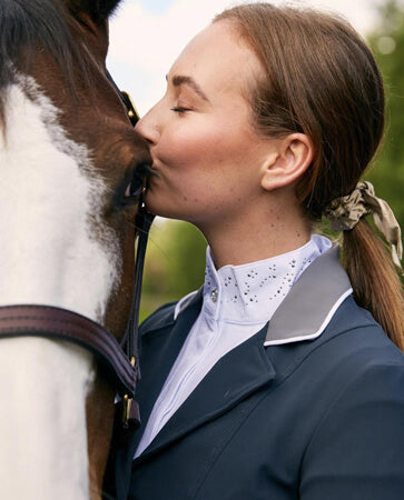 Horse rider using presents she has been given as gifts to groom her horse and detangle its tail