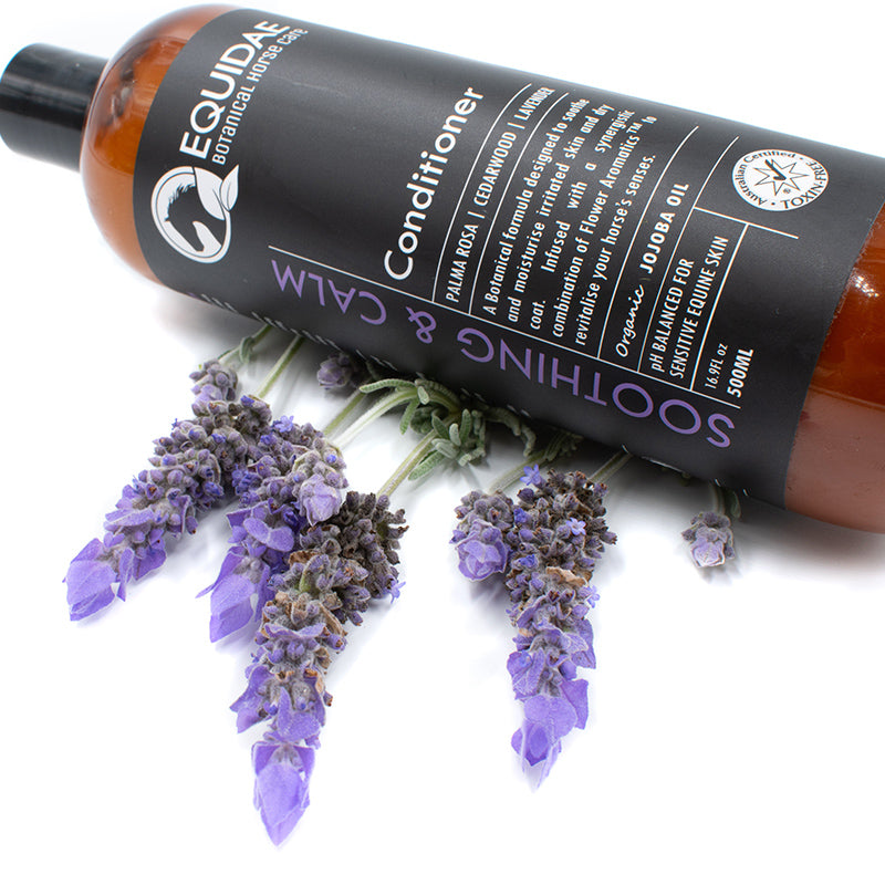 Soothing & Calm horse conditioner on table surrounded by natural ingredients used to detangle horses tail and create a shiny, healthy coat